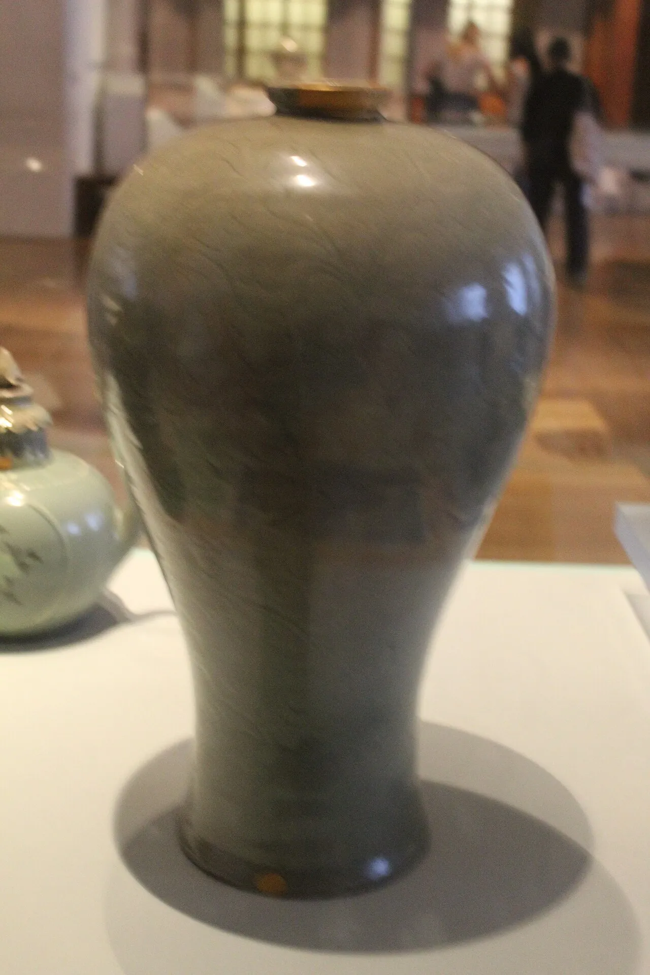 A tall, elegant Goryeo celadon bottle with a soft jade-green glaze